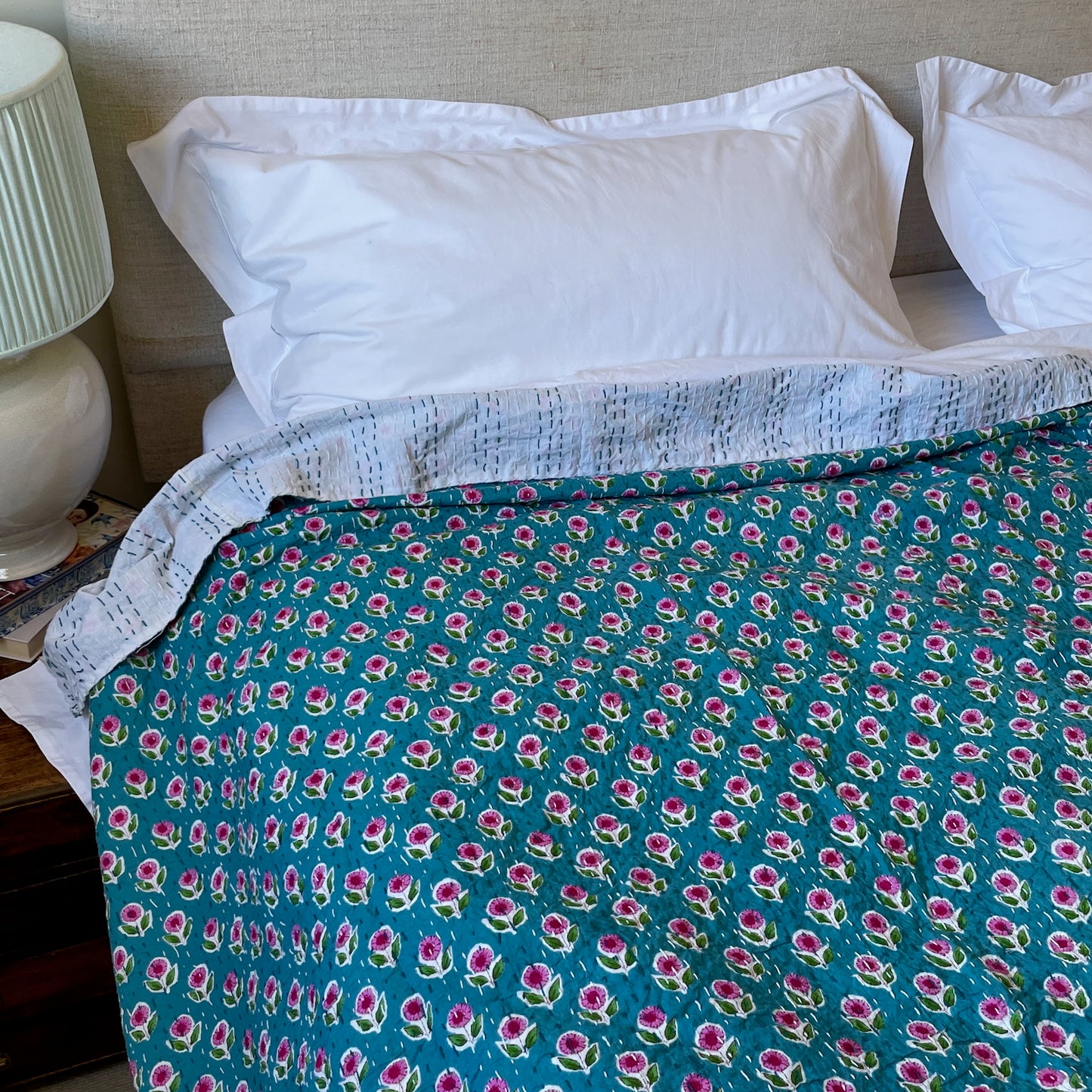 teal and pink floral quilt on bed with fresh white bedding machine washable kantha UK